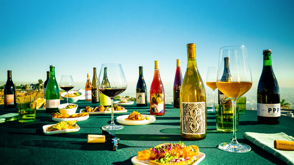 An image of wine and food on a green table cloth, this is for presentation purposes only for our homepage. 